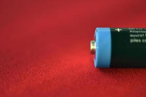 AA finger battery on a red background photo