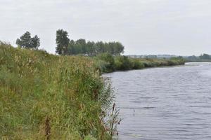 River and mountain with trees in the steppe field photo