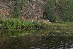 River and mountain with trees in the steppe field photo