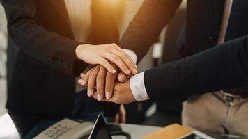 Close up on hands of business people join together their hands together on unity concept photo