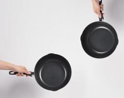 Hand cleaning the non stick pan with handy dish washing sponge photo