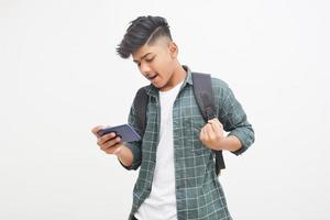 Indian college student using smartphone on white background. photo