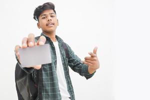 Young indian man showing debit or credit card on white background. photo