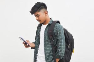 Indian college student using smartphone on white background. photo