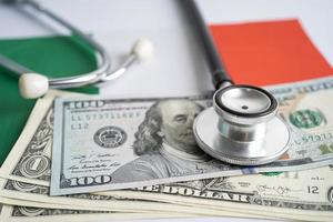 Black stethoscope with US dollar banknotes on Italy flag background, Business and finance concept. photo