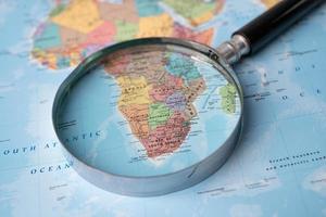 Bangkok, Thailand - August 01, 2021 Africa, Magnifying glass close up with colorful world map photo