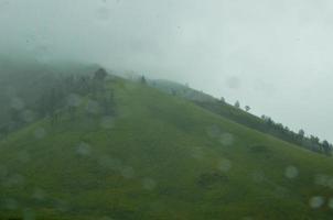 misty green hills. hills and mountains background. location on mount bromo photo