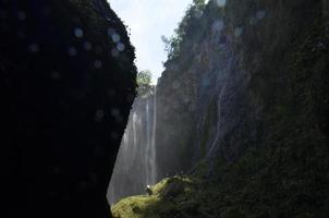 view of the valley and caves with waterfalls in the background. summer background and waterfall photo