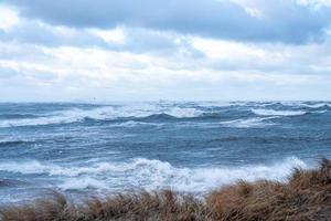 Thunder storm waves crashing on the beach photo