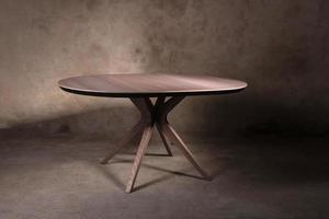 Beautiful brown wooden folding table on beige concrete background photo