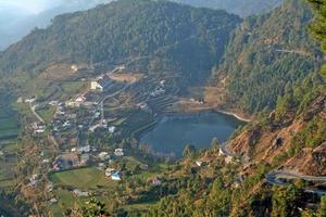 View of lake surrounded by mountains near Nainital photo