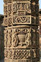 Carving of intricate design in stone pillar photo
