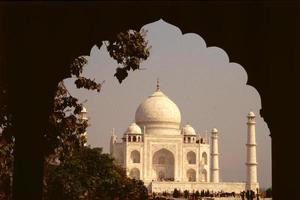 Dark arched frame to magnificent marble edifice Taj Mahal photo