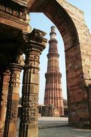 Qutb Minar framed in surrounding structure photo