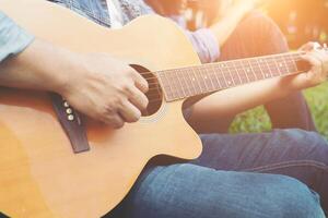 Man's hand holding guitar chords, train all the time. photo