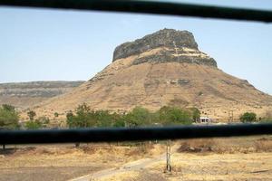 View of rocky hill captured during train journey photo