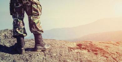 Soldier on the top of a mountain photo