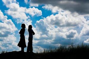 silhouette couple of girls walking photo