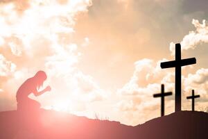 Silhouette of woman praying over beautiful sky background photo