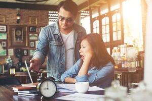 Boss shouting to a stressed employee when she work with laptop at office, talking about not complete by work, Business fail concept. photo