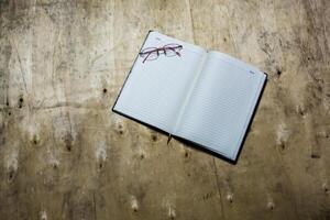 Empty notepad with glasses on a wooden desk. photo