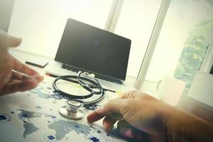 Doctor working with laptop computer in medical workspace office and medical network media diagram as concept photo