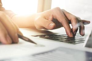 close up of businessman hand working with new modern computer photo