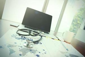 Doctor workspace with laptop computer in medical workspace office and medical network media diagram as concept photo