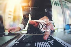 businessman working with digital tablet computer and smart phone with digital business strategy layer effect on wooden desk as concept photo