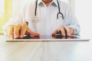 Medicine doctor hand working with modern digital tablet pad as medical network concept photo