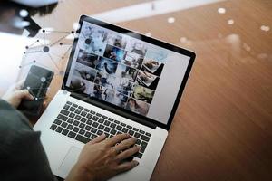 top view of businessman hand working with new modern computer and smart phone and business strategy on wooden desk as concept photo