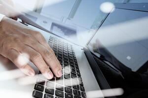 Double exposure of businessman hand working with new modern computer and business strategy as concept photo