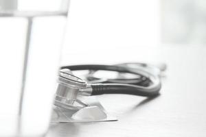 Studio macro of a stethoscope and pills  on wood table background copy space photo