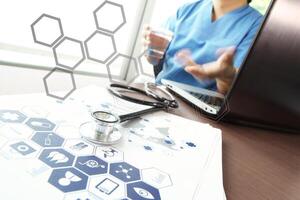 Doctor working with  laptop computer in medical workspace office and medical network media diagram as concept photo