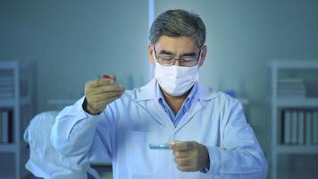 Scientist holding liquid chemical tube in laboratory, Science and technology healthcare concept video