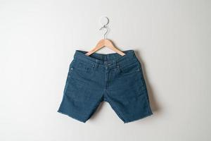 short pants jeans hanging on hanger photo