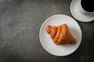 fresh croissant on white plate photo