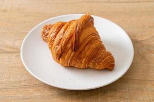 fresh croissant on white plate photo