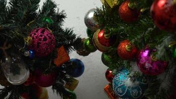 Greeting Season concept.hand setting of ornaments on a Christmas tree with decorative light photo