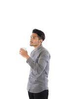 Handsome young hipster man holding coffee cup standing with isolated on white background. photo