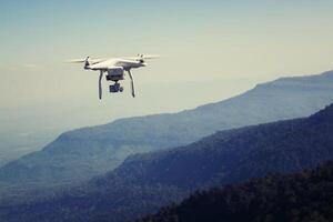 flying drone with camera on the mountain photo