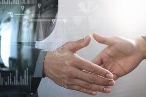 Business partnership meeting concept.photo businessmans handshake. Successful businessmen handshaking after perfect deal.close up,virtual graph chart interface screen photo