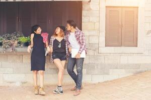 Group of Teenagers Hanging Out In Urban Environment , Summer holiday ,Enjoyment cheerful together. photo