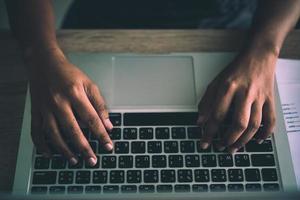 Close Up of a business woman hands typing on a laptop. photo