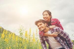 Girlfriend ride back of boyfriend,Girlfriend shoot picture with her boyfriend making good time and enjoying together. photo