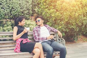 Young hipster couple teenagers in love in the city, Summer holiday enjoyment together. photo