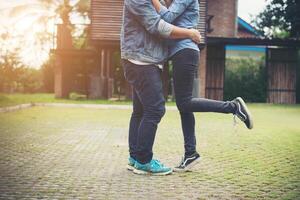 Hipster couple in love kissing in summer sun light. Love kiss standing. photo