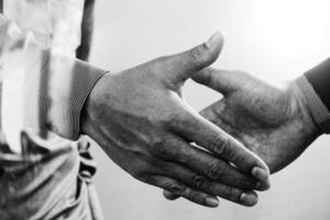 Business partnership meeting concept.photo businessmans handshake. Successful businessmen handshaking after perfect deal.close up,black and white photo