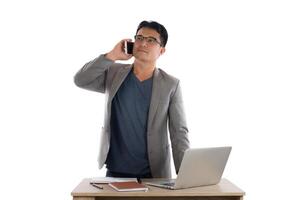 Businessman working on laptop and calling on phone, white background. photo