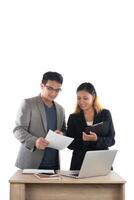 Young business woman standing with her boss conversation about the business at office isolated on white background. photo